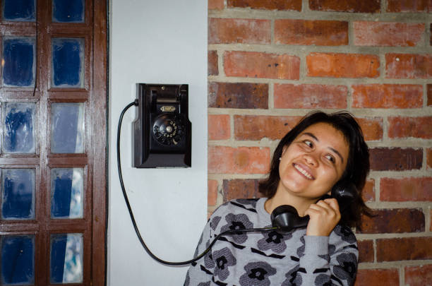 brunette using old retro phone at home stock photo