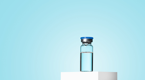Glass Medicine Vial jar botulinum toxin with medical on blue background. A preparation for cosmetology rejuvenating procedures, biorevitalization, mesotherapy, anti age. Mock up
