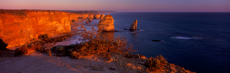 Wide angle panoramic view of the Twelve Apostles on sunset along the Great Ocean Road in Victoria.