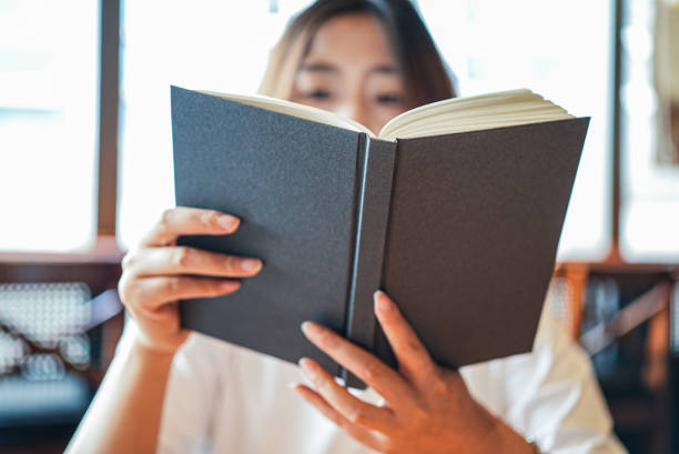 istock Close-up woman reading a book 1672993903