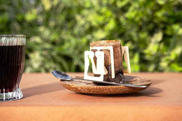 istock Used drip coffee bag near coffee cup in morning light. 1673011423