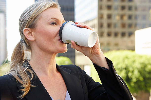 istock Businesswoman Drinking Takeaway Coffee Outside Office 167304640