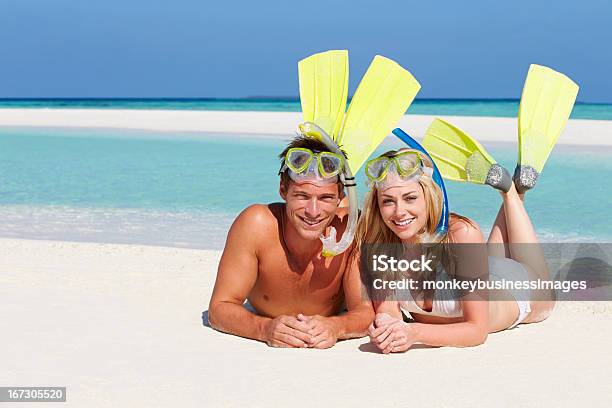 Couple With Snorkels Enjoying Beach Holiday Stock Photo - Download Image Now - Couple - Relationship, Snorkel, Women