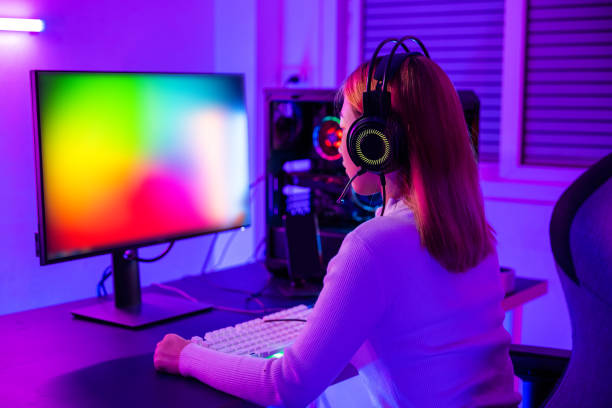 istock Asian professional gamer playing online video game on desktop computer PC have colorful neon LED lights 1673055203