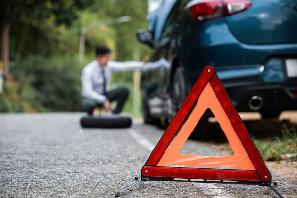 istock Close of red warning triangle and man blur background. 1673055219