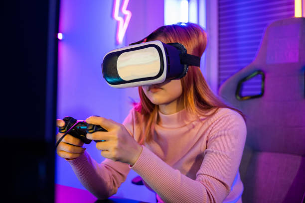 istock Gamer in VR headset glasses exploring metaverse play video game online with joystick 1673055731