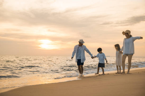 istock Happy family having fun running on a sandy beach at sunset time 1673055865