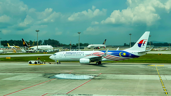 Changi, Singapore - September 6, 2022 : An Airplane Of Malaysia Airlines Moved To Runway By Pushback Tractor In Changi Airport.