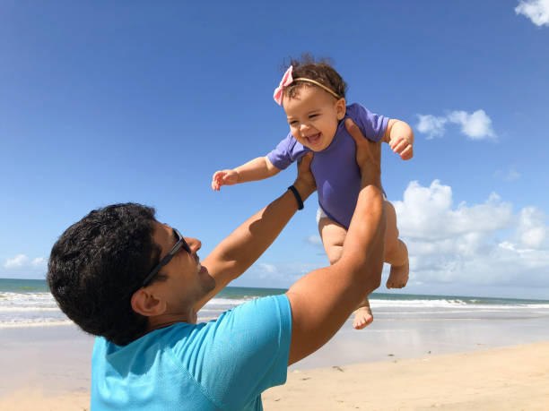 istock Father plays with his daughter on the beach 1673072444
