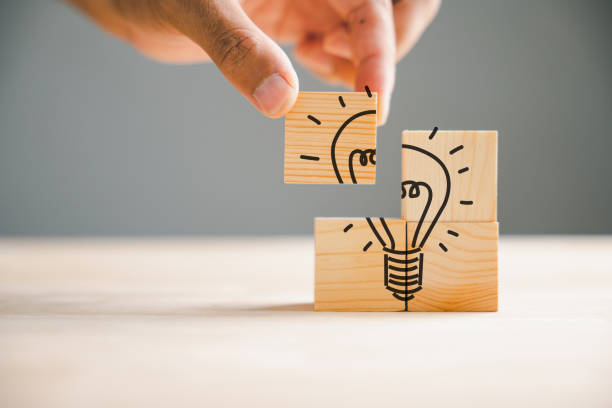 istock Idea and creativity concept portrayed through a wooden cube with a light bulb icon 1673084719