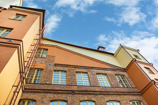 istock renovated old red brick industrial building against cloudy sky. bottom view. 1673117716