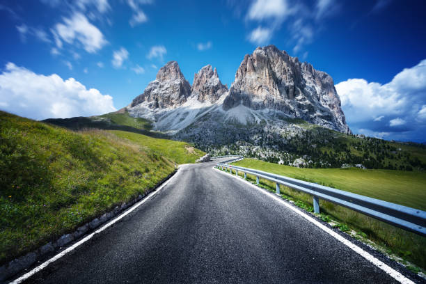 Highway through Dolomites valley. Northern italy. Highway through Dolomites valley. Northern italy. winding road mountain stock pictures, royalty-free photos & images