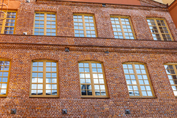 istock red brick classic industrial building facade with multiple windows. 1673119064
