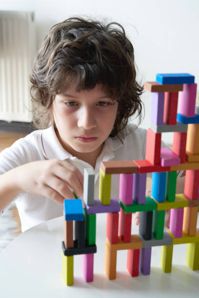 istock Cute Little Boy Playing with wooden block 1673128820