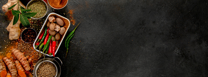 Spices on dark background. Different varius. Top view, copy space.
