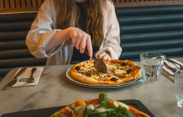 istock View of vegetarian pizza being cut with pizza cutter 1673182956