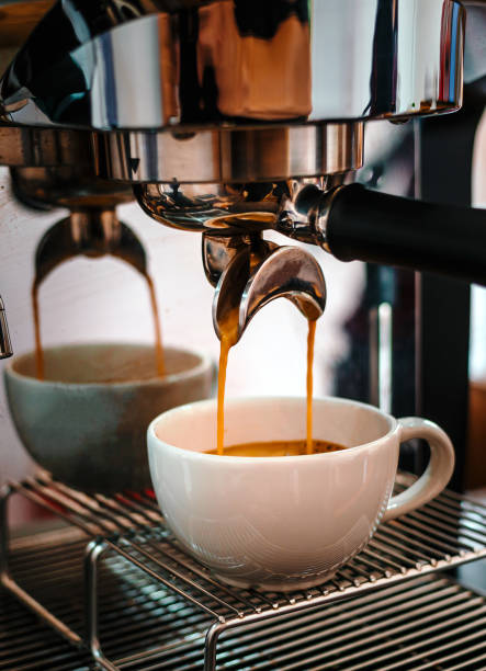 istock Coffee extraction from the coffee machine with a portafilter pouring coffee into a cup,Espresso pouring from the coffee machine at coffee shop 1673186489