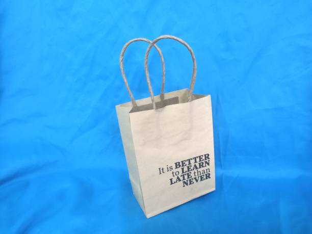 istock recycle paper shopping bag  on blue background. 1673186854