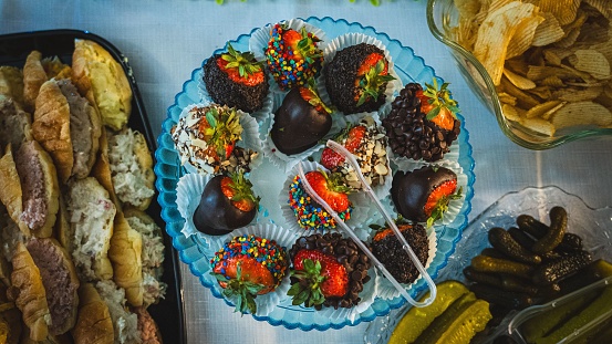 A top view of a plate of chocolate-covered strawberries for a banquet
