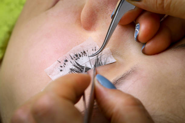 istock Eyelash extension procedure, woman eye with Long eyelashes 1673216252