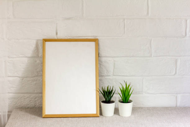 istock An empty photo frame on a table or shelf with a copy of the space. 1673228366
