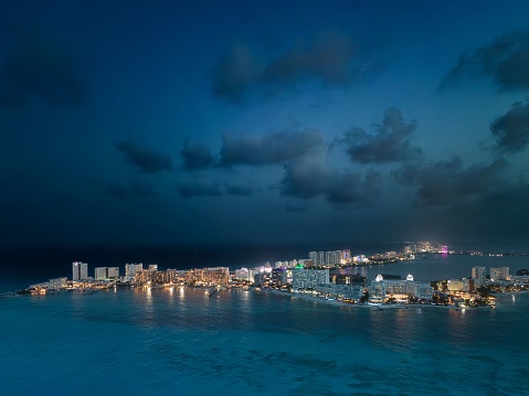 An aerial view of hotels on the beach at night in Cancun, Mexico