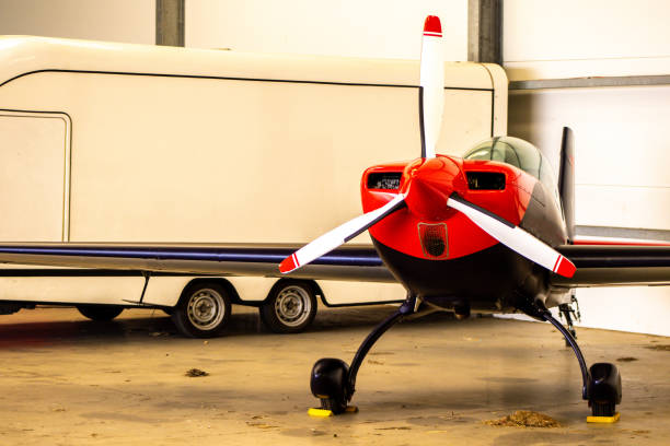 various airplanes standing in the hangar under cover.