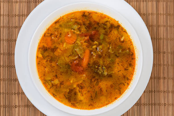 istock Vegetable red soup in bowl on place mat, top view 1673329710