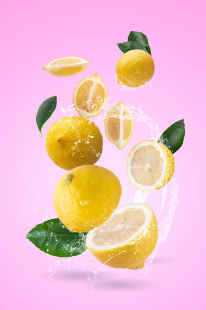 istock water splash on yellow lemon isolated on a pink background. 1673341276