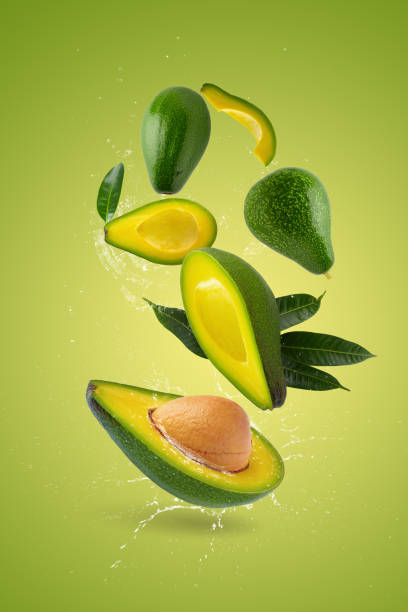 istock Green ripe avocado on a green background and Water splashing 1673341281
