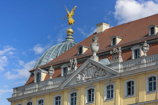 Dresden, Germany - September 23, 2020: Decorative facade of a historic building in the New Market square (Neumarkt). Dome of Dresden Academy of Fine Arts in the distance