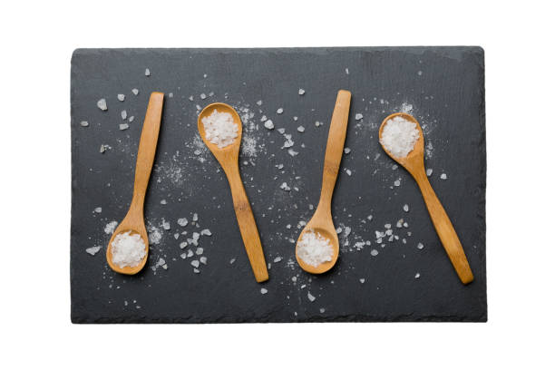 istock salt on many wooden spoon isolated on white background. Spoons with different salt 1673351936