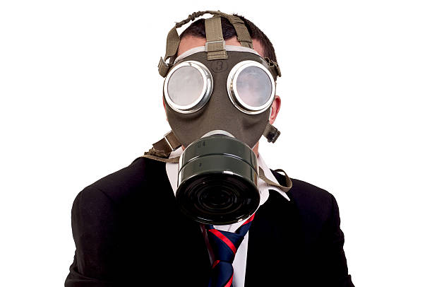 istock business man with gas mask over white background 167335844