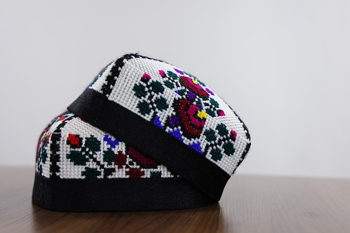 Uzbek traditional hat with embroidery on a white background