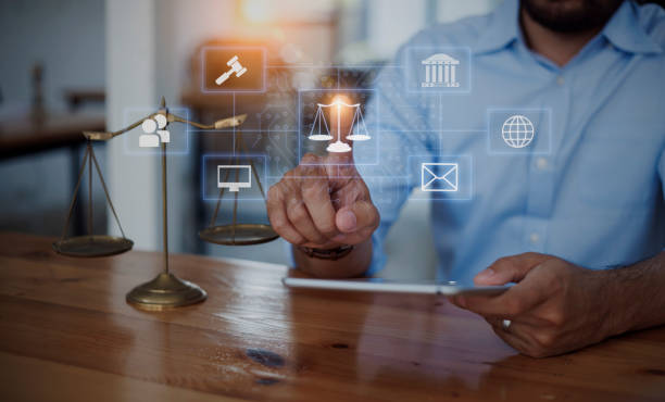 istock Lawyer hands holding digital tablet with law network interface icons. 1673371294