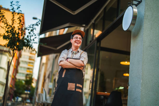 Female Barista opening her coffee shop in the morning. stock photo