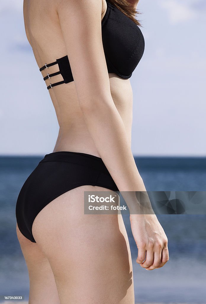 Body of young woman on beach 2013 Stock Photo