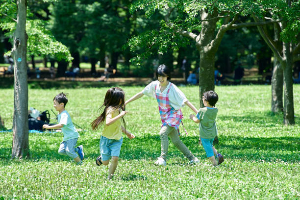istock A woman in an apron with children playing chasing 1673441961