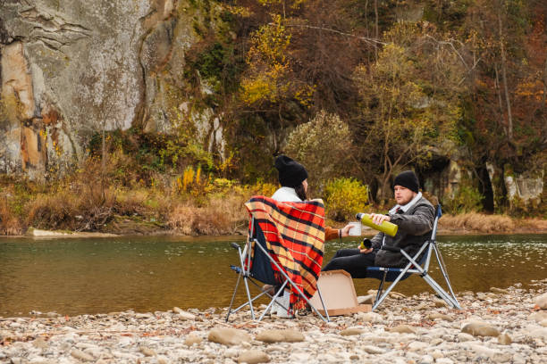 istock happy couple having picnic at river beach 1673447284