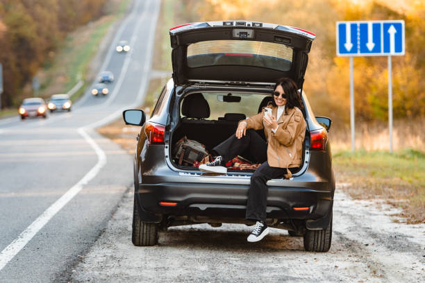 istock A woman surfs on her smartphone in the trunk 1673447318
