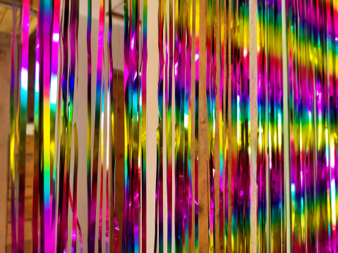 Festive multicolored Rainbow shiny beautiful Christmas New Year Tinsel garland. Texture. Background