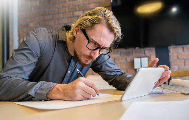 istock Close up hand drawing industrial design engineering interior paper.  Male engineer architect blueprints laying on table, use pencil. Banner  focus on hands architect sketch project on blueprint. 1673465519