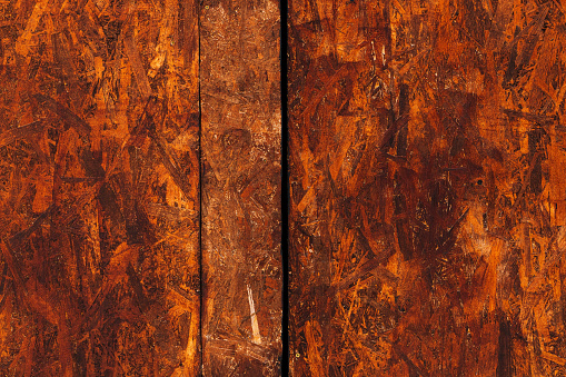Oriented strand board (OSB) surface as background, brown painted wood