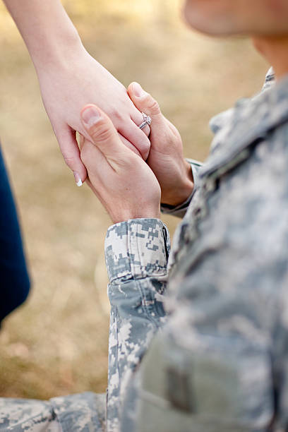 Soldier proposing to his girlfriend stock photo