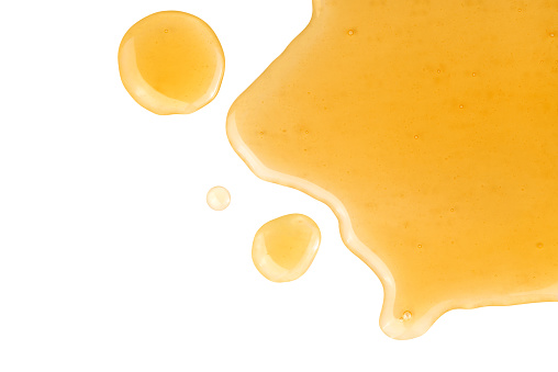 Spilled honey isolated on white background.