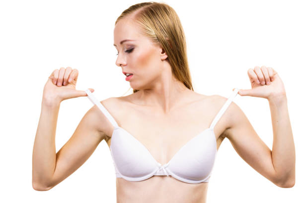 istock Young woman holding bra strap 1673506196