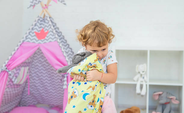 The child is playing with the cat. Selective focus.