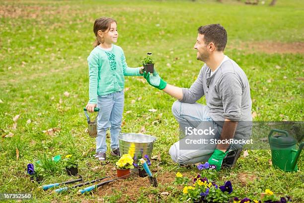 Father And Daughter In The Garden Stock Photo - Download Image Now - 30-39 Years, Adult, Cheerful