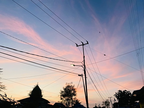 Electric poles with a beautiful yellow evening sky in the background