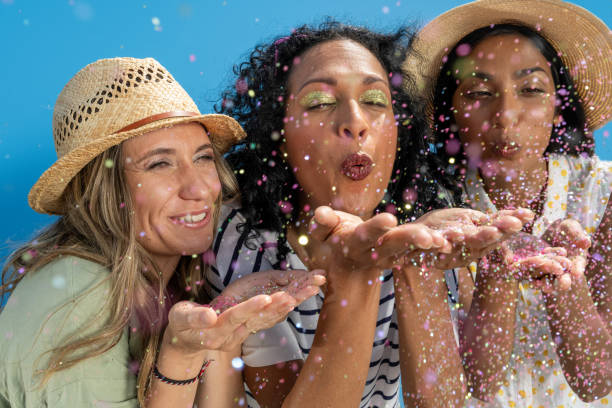 istock Women blowing confetti 1673542975